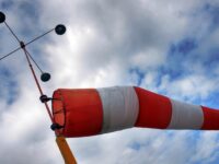 Wind sack with cloudy sky and aerometer.